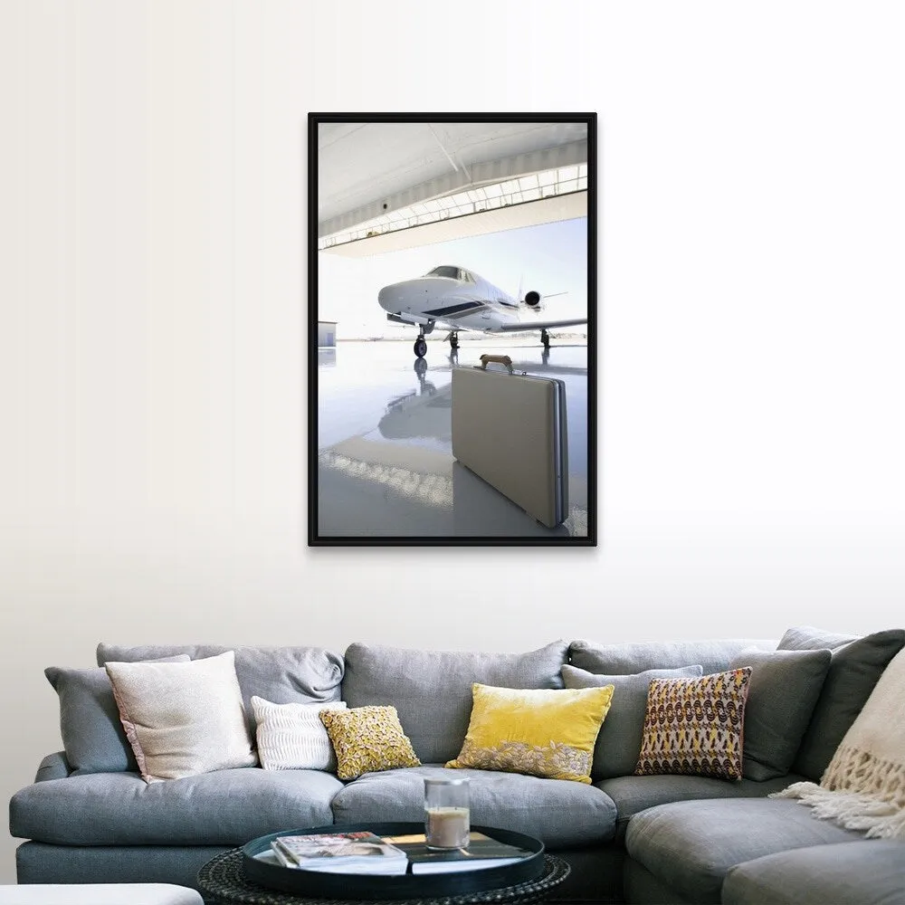 "Briefcase left in hangar near the jet" Black Float Frame Canvas Art