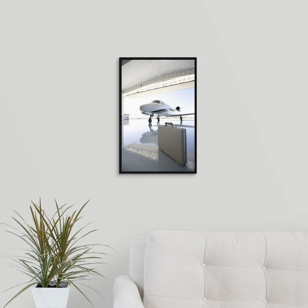 "Briefcase left in hangar near the jet" Black Float Frame Canvas Art