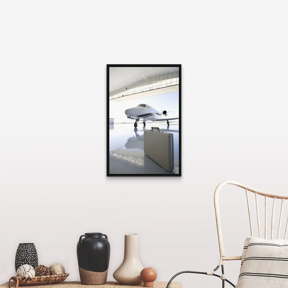 "Briefcase left in hangar near the jet" Black Float Frame Canvas Art